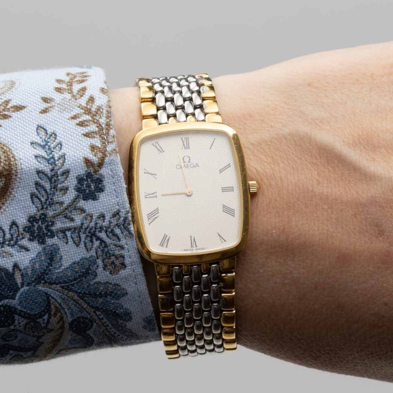 Omega de Ville from 1990s Ref. 3950876. Quartz movement. Gold on steel. Roman indexes on white dial.